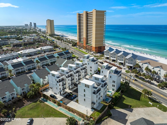 bird's eye view with a water view and a beach view