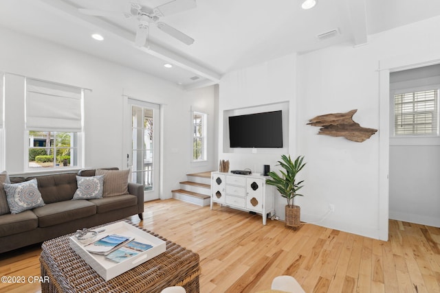 living room featuring ceiling fan, beam ceiling, and hardwood / wood-style floors