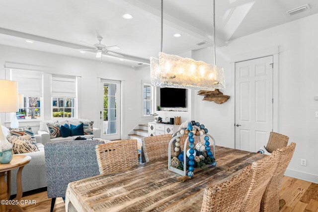 dining area featuring beam ceiling and light wood-type flooring