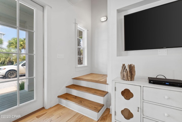 stairs featuring hardwood / wood-style floors