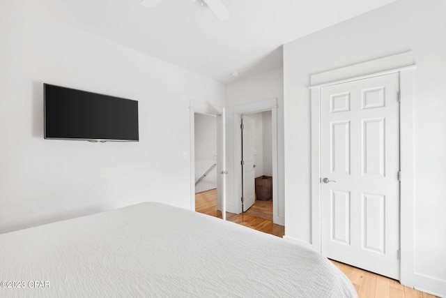 bedroom featuring hardwood / wood-style floors, a closet, and ceiling fan