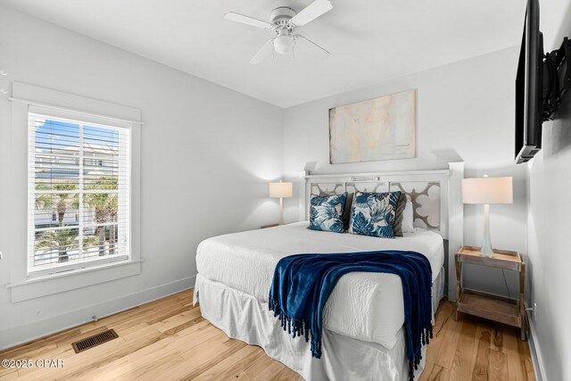 bedroom with hardwood / wood-style floors and ceiling fan