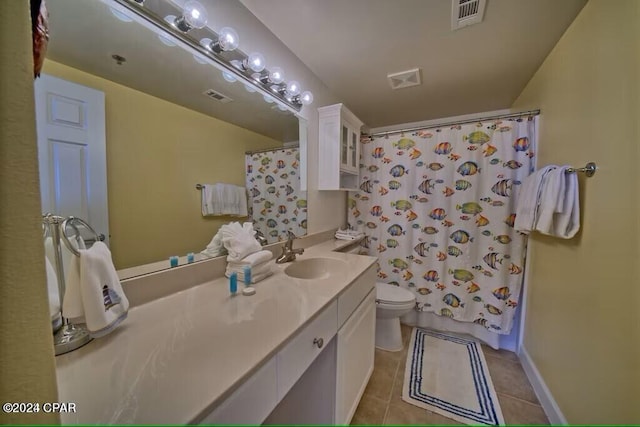 bathroom featuring tile patterned floors, vanity, and toilet