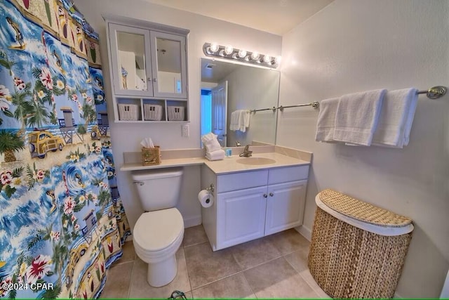 bathroom featuring toilet, vanity, and tile patterned floors