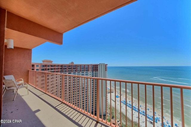 balcony with a beach view and a water view