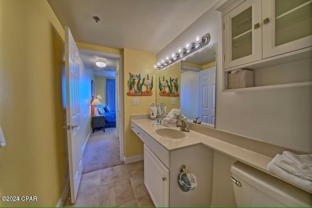 bathroom with tile patterned floors, vanity, and toilet