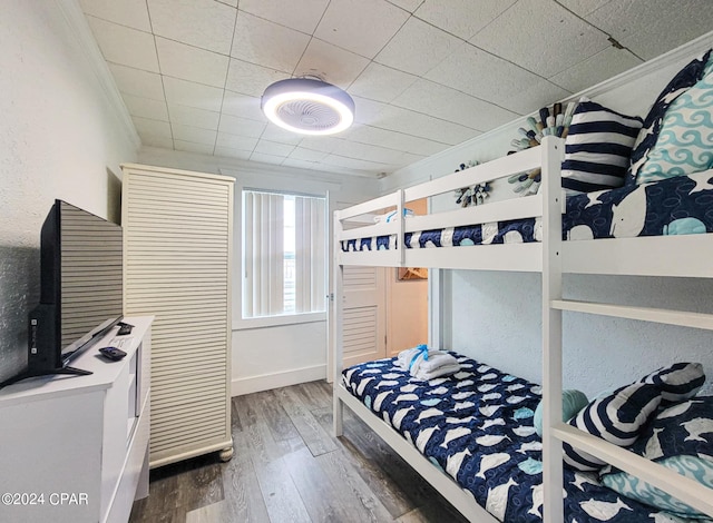 bedroom featuring hardwood / wood-style floors and ornamental molding