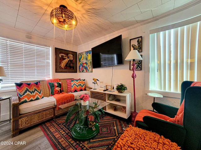 living room with hardwood / wood-style floors and crown molding