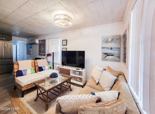 living room with light hardwood / wood-style flooring, crown molding, and a wall mounted air conditioner