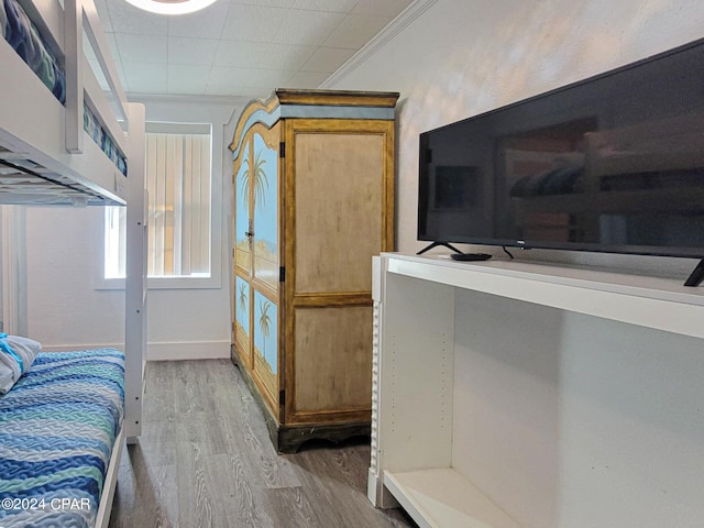 interior space featuring light hardwood / wood-style floors and ornamental molding