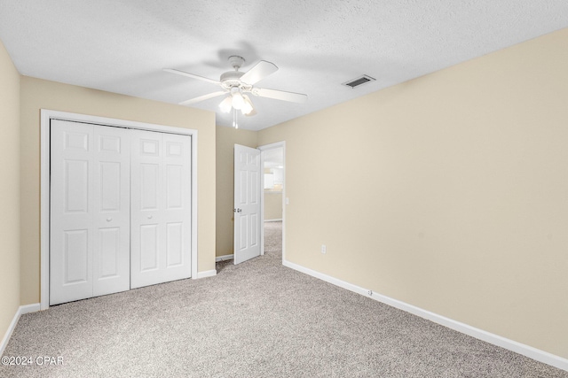 unfurnished bedroom with carpet flooring, a closet, and ceiling fan