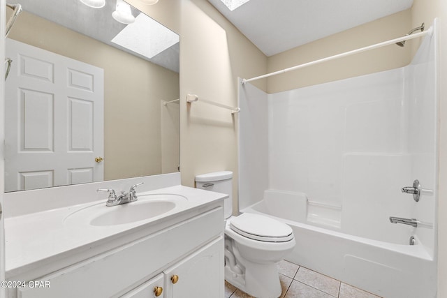 full bathroom featuring vanity, tile patterned floors, a skylight,  shower combination, and toilet