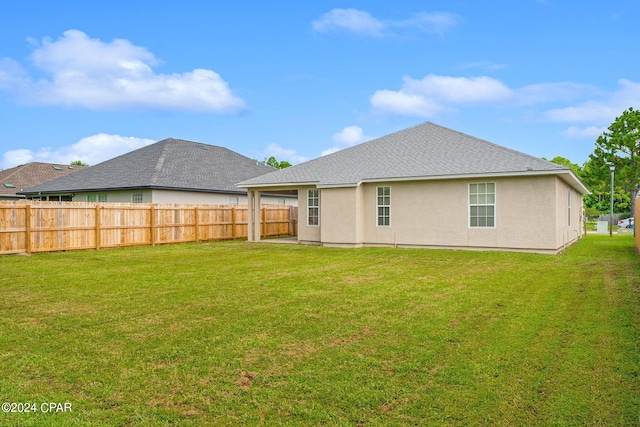 back of property featuring a lawn