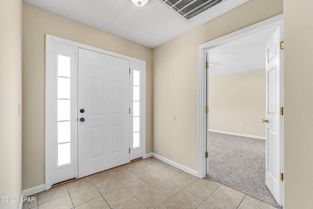 tiled foyer with a healthy amount of sunlight