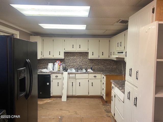 kitchen with cream cabinets, sink, backsplash, and black fridge with ice dispenser