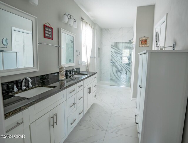 bathroom with tile patterned floors and dual vanity