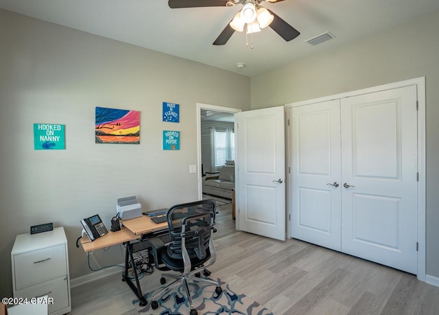 office space with light hardwood / wood-style floors and ceiling fan