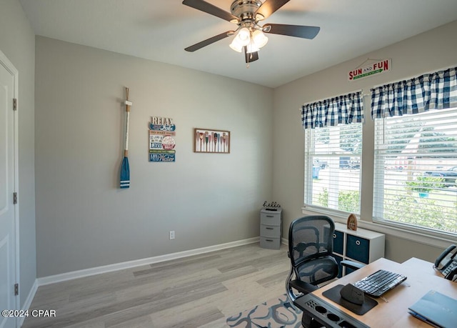 office with ceiling fan and light hardwood / wood-style floors