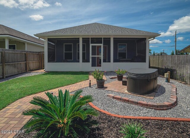 rear view of house with a sunroom and a patio area