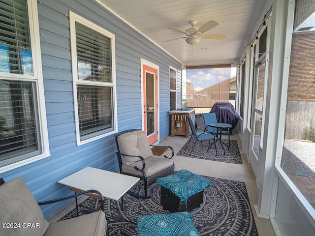 sunroom / solarium featuring ceiling fan