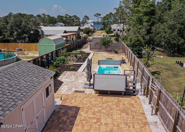 view of pool featuring a patio and a shed