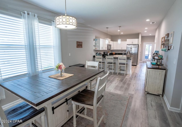 dining space with light wood-type flooring