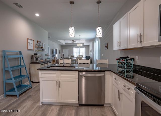 kitchen featuring light hardwood / wood-style flooring, sink, stainless steel dishwasher, and kitchen peninsula