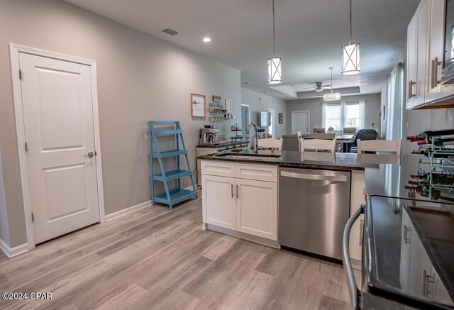 kitchen featuring light wood-type flooring, sink, dishwasher, and white cabinets