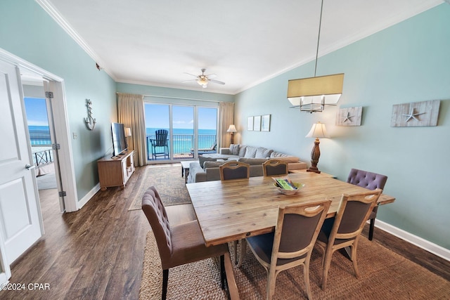 dining room with dark hardwood / wood-style flooring, crown molding, and ceiling fan