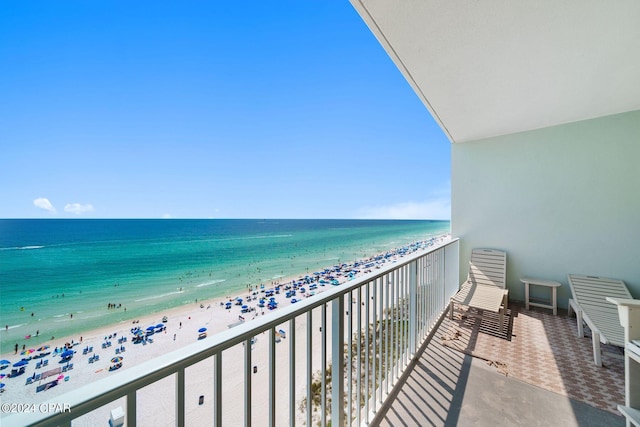 balcony featuring a beach view and a water view