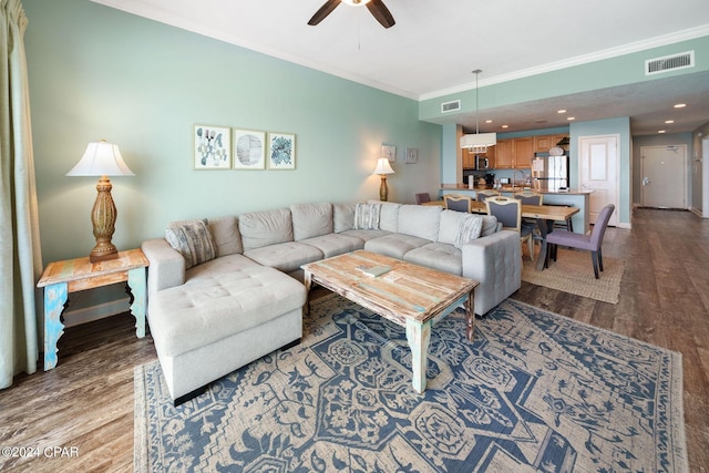 living room with light wood-type flooring, crown molding, and ceiling fan