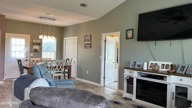 living room featuring vaulted ceiling and hardwood / wood-style flooring