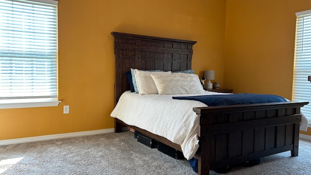 carpeted bedroom featuring multiple windows