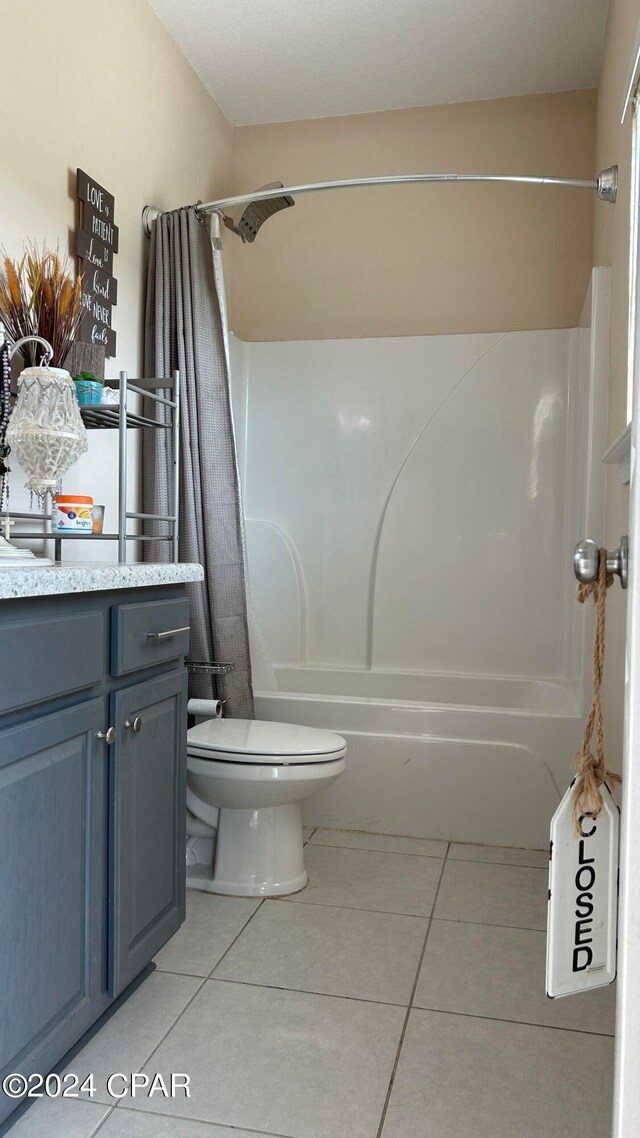 full bathroom featuring shower / tub combo with curtain, vanity, toilet, and tile patterned flooring