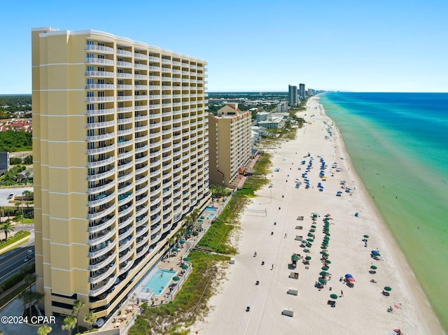 aerial view featuring a water view, a view of city, and a beach view