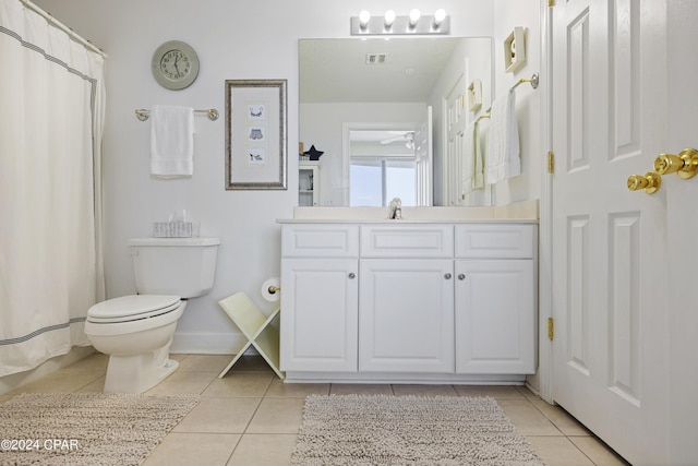 full bathroom with toilet, vanity, baseboards, visible vents, and tile patterned floors