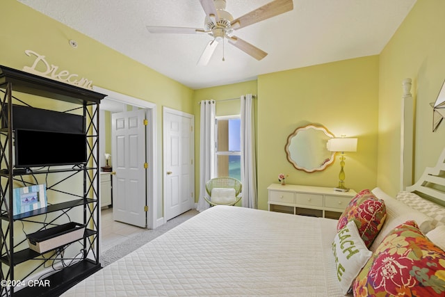 bedroom featuring a textured ceiling and a ceiling fan