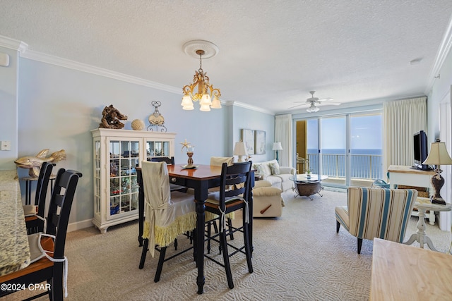 carpeted dining space with a textured ceiling, baseboards, and crown molding