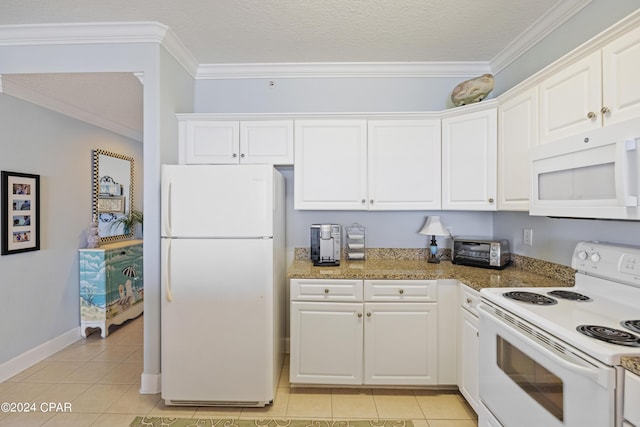 kitchen with light tile patterned floors, white appliances, and white cabinetry