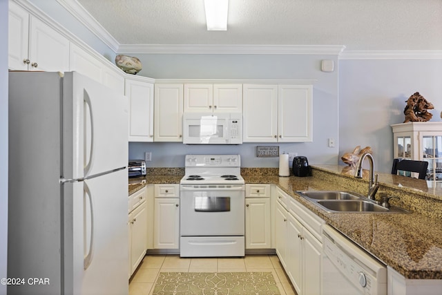 kitchen featuring light tile patterned flooring, a peninsula, white appliances, a sink, and crown molding