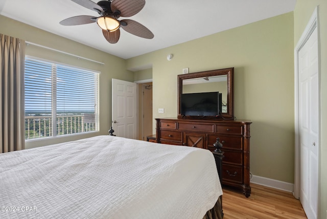 bedroom featuring light wood-type flooring, a closet, and ceiling fan