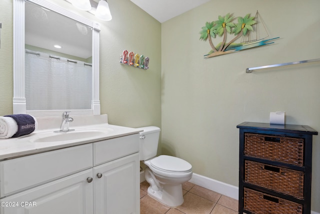 bathroom with tile patterned floors, vanity, and toilet