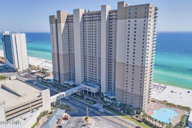 exterior space featuring a water view and a beach view