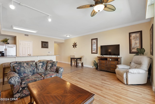 living room featuring ceiling fan, light hardwood / wood-style flooring, ornamental molding, and rail lighting