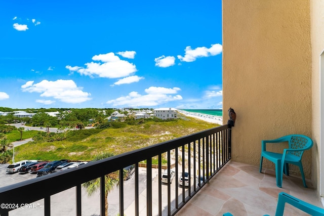 balcony with a water view and a beach view