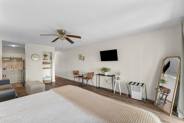 bedroom featuring hardwood / wood-style floors and ceiling fan