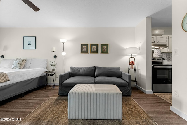 living room featuring dark hardwood / wood-style flooring and ceiling fan