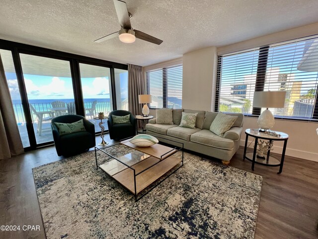 living room featuring a textured ceiling, a healthy amount of sunlight, and hardwood / wood-style flooring