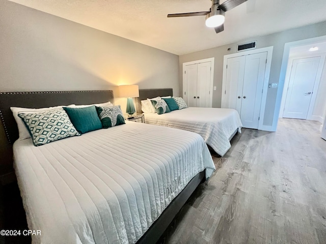 bedroom with ceiling fan and light wood-type flooring