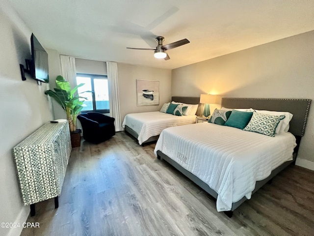 bedroom with hardwood / wood-style floors and ceiling fan